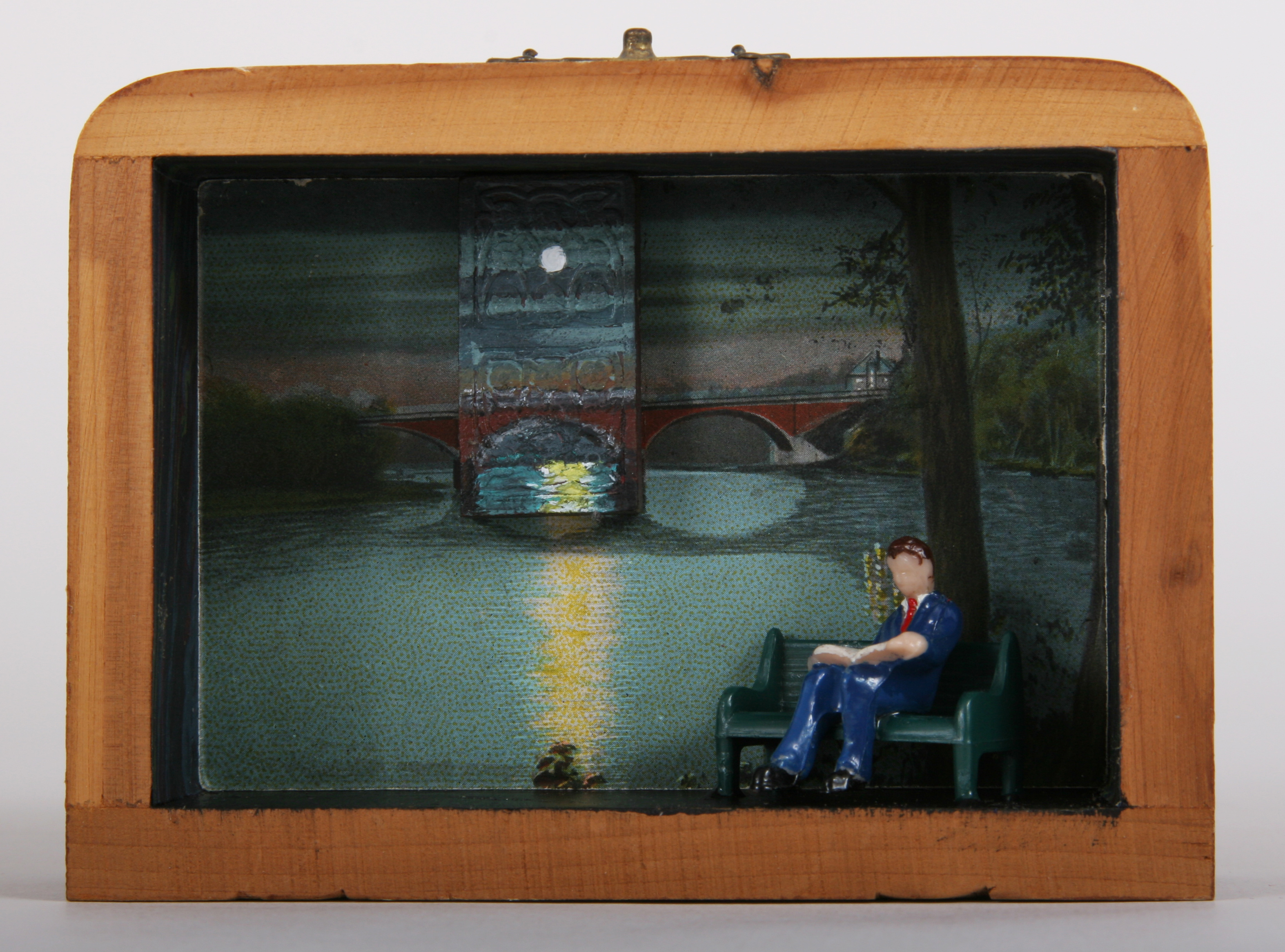     \"Moonlight Scene #14: Reading on Bench\"
    mixed-media assemblage
    5 x 3.5 x 1.5
    2009

    SOLD

    Assemblage in old wood cedar souvenier box with acrylic on vintage wood domino, vintage postcard, plastic figure & bench, paper