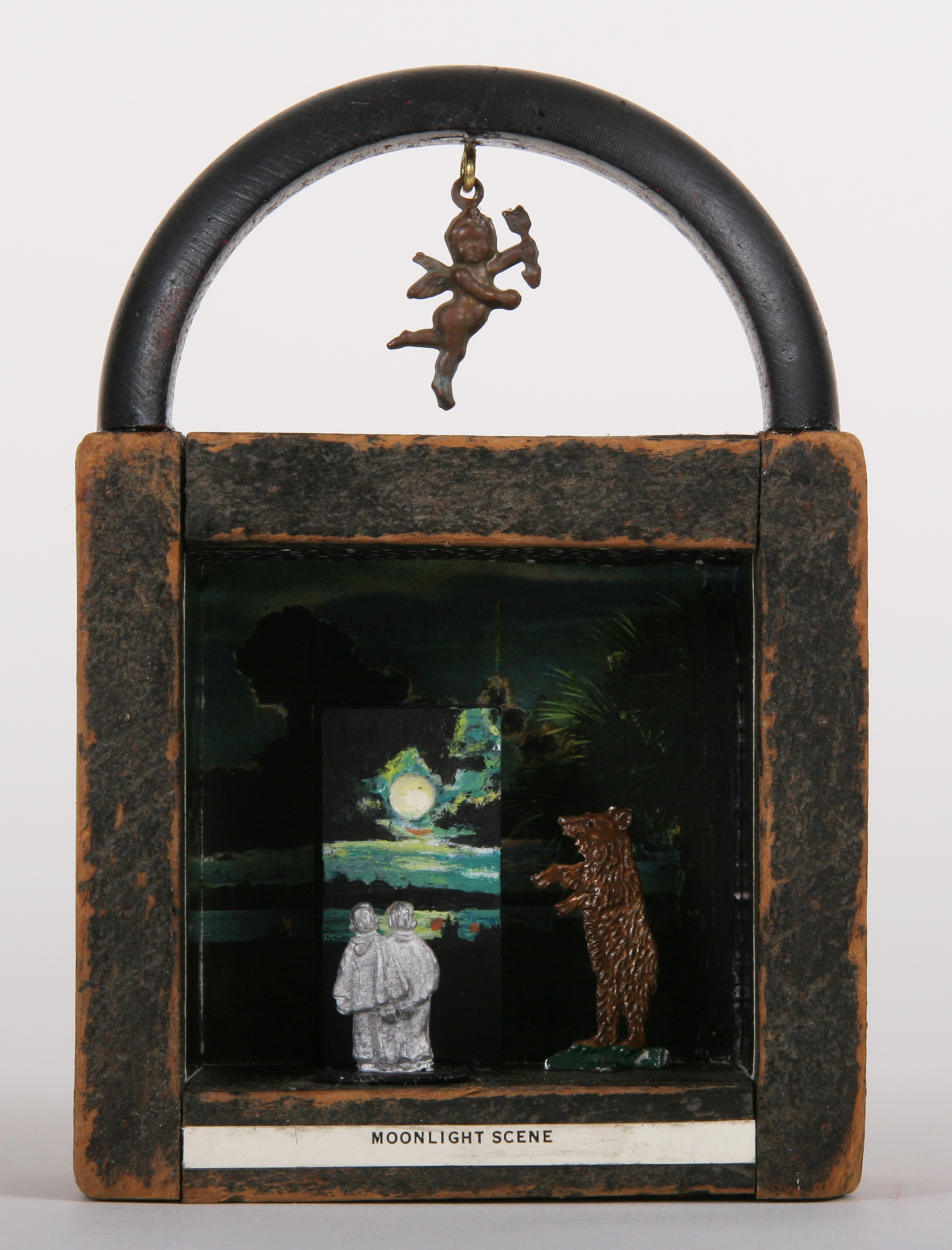     \"Moonlight Scene #1: Couple With Bear\"
    mixed-media assemblage
    5.75 x 3.625 x 1.5
    2009

    SOLD

    Wood foundry pattern, acrylic painting of moon on wood domino with vintage postcard, metal toy figures, angel charm, bracelet, enamel