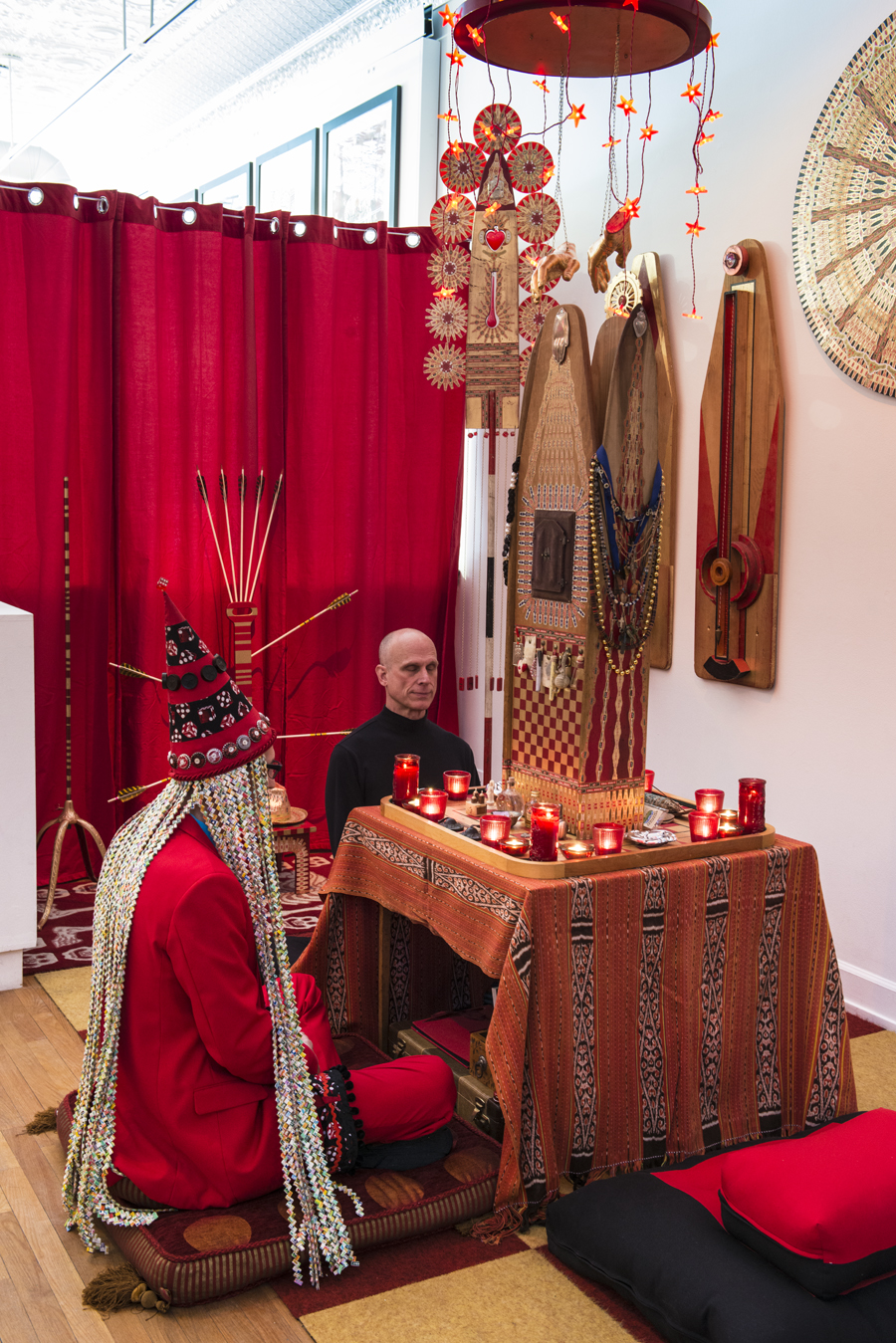 Shaman Johnny sitting with a visitor in front of the \"Reliquary of Protection\" in the meditation area. 