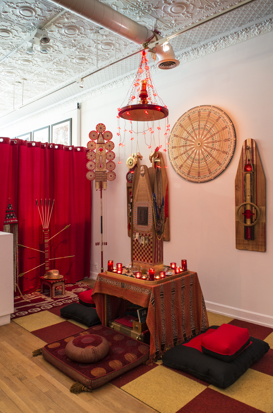 Meditation area of Sacred Backroom at Shaman Johnny\'s Pop-Up Shop & Gallery. (L to R in back ground) \"Shaman Johnny\'s Crown\", \"Throne of St. Sebastian\", \"Staff of Compassion\", \"Visual Prayers\", and \"Halo\". \"Reliquary of Protection\" on table. 